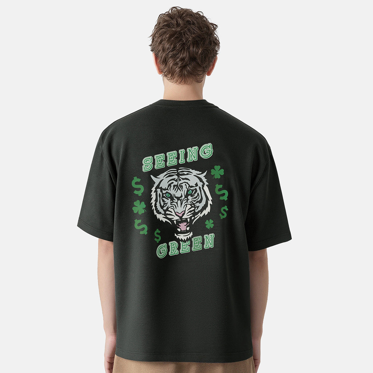 Person wearing a black t-shirt with a tiger graphic and text on the back, on a white background