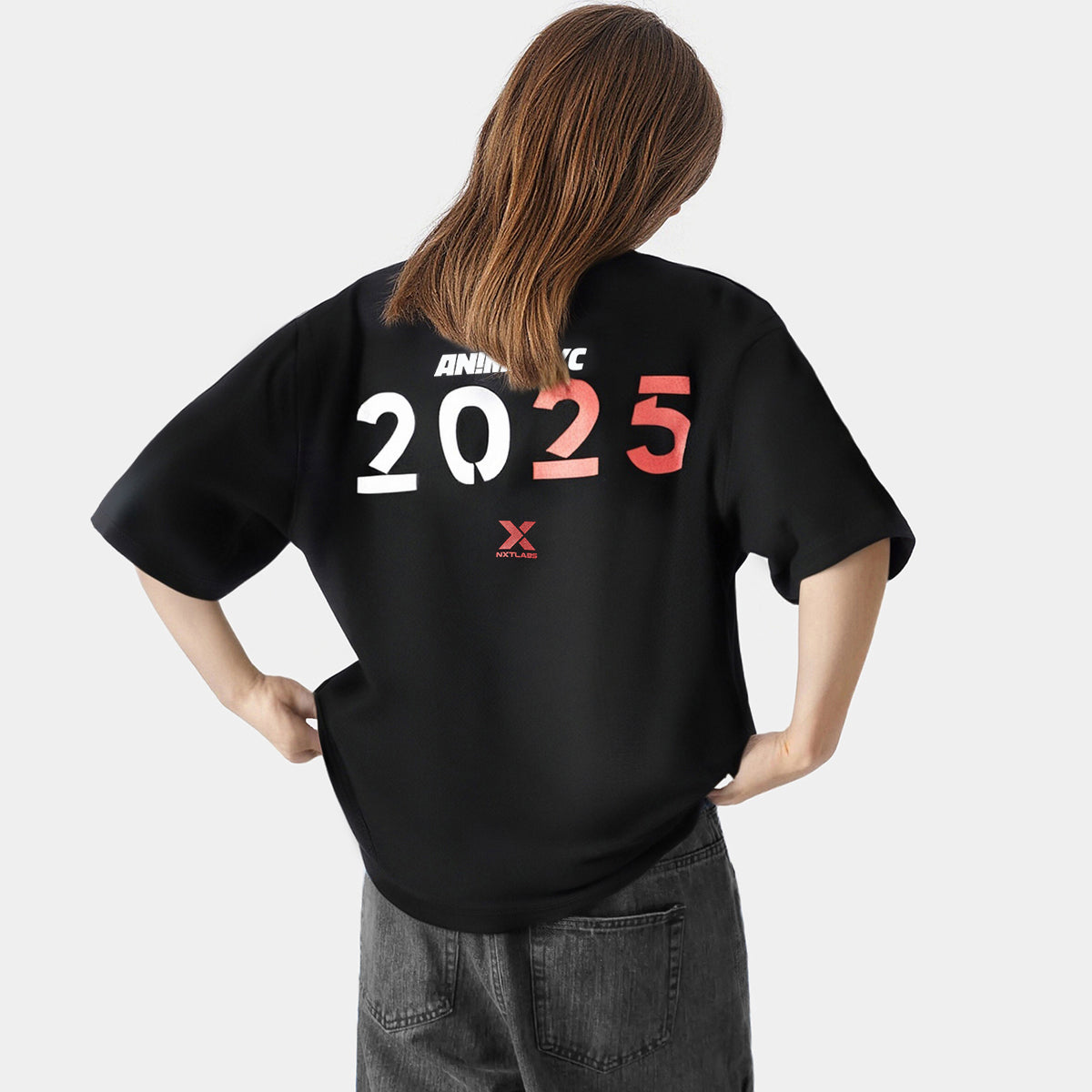Person wearing a black t-shirt with '2025' printed on the back against a white background