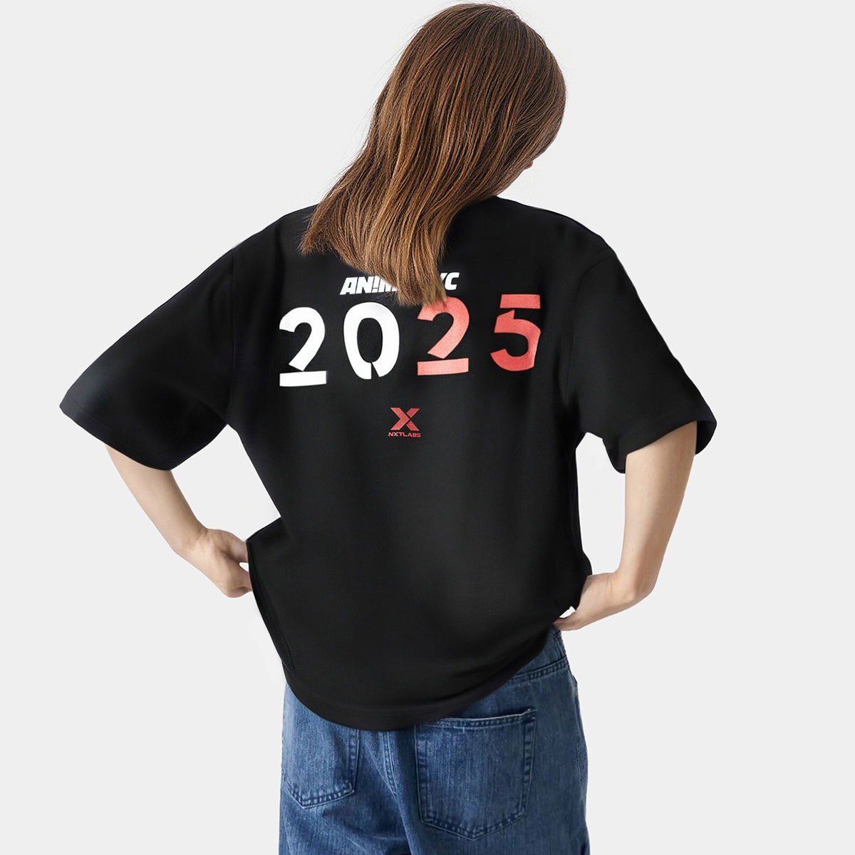Person wearing a black t-shirt with '2025' printed on the back against a white background