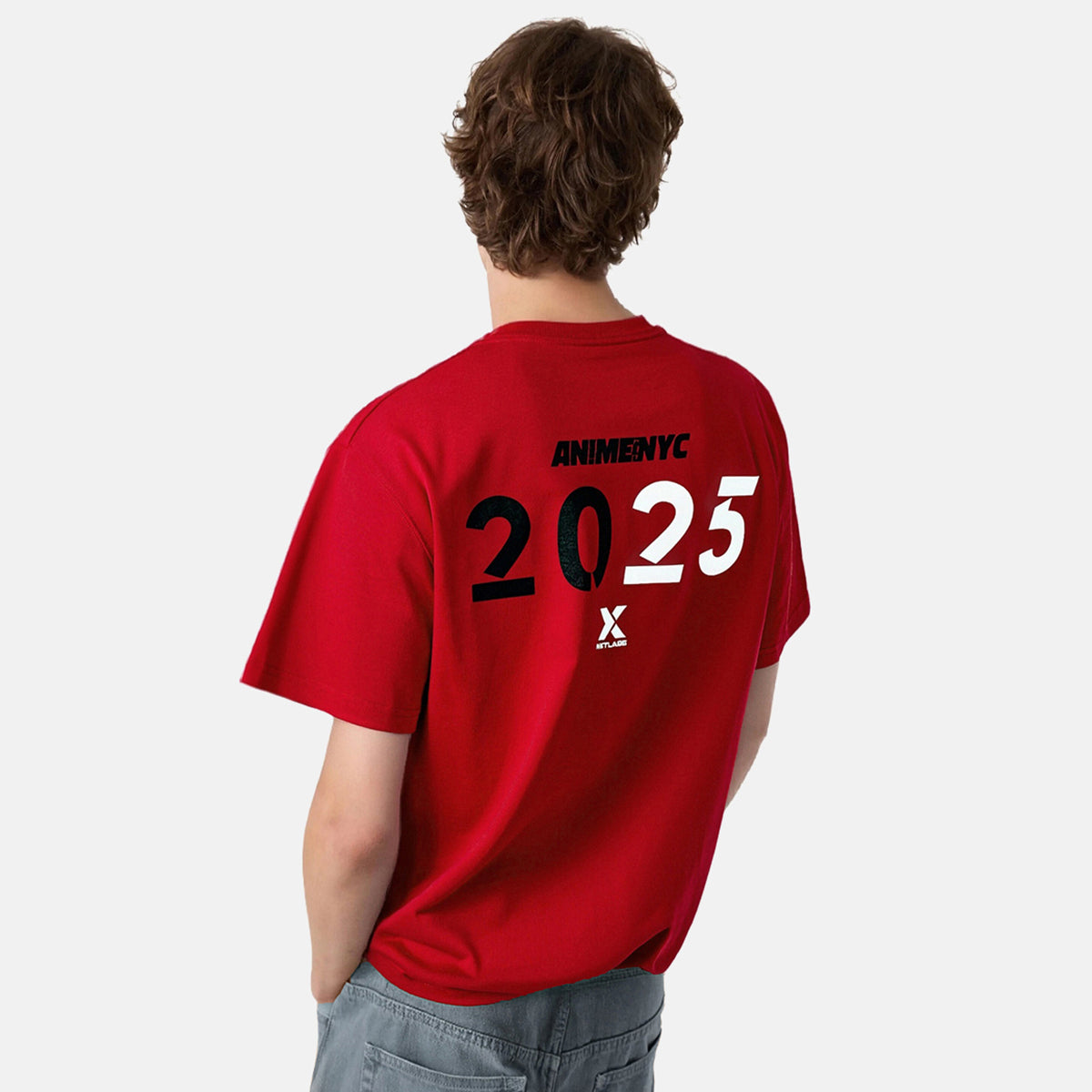Person wearing a red t-shirt with 'ANIMENYC 2025' printed on the back against a white background