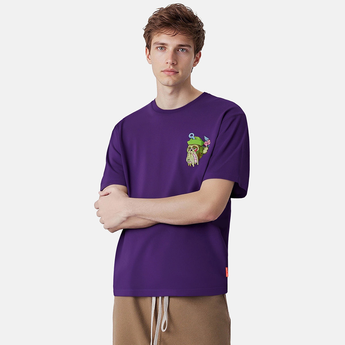 Man wearing a purple t-shirt with a graphic design on a white background