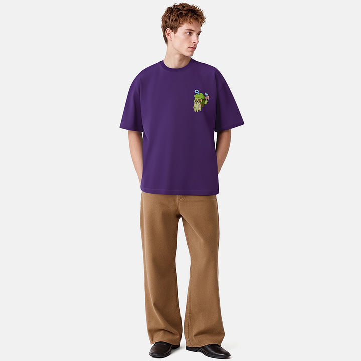 Person wearing a purple t-shirt with a graphic design on a plain background