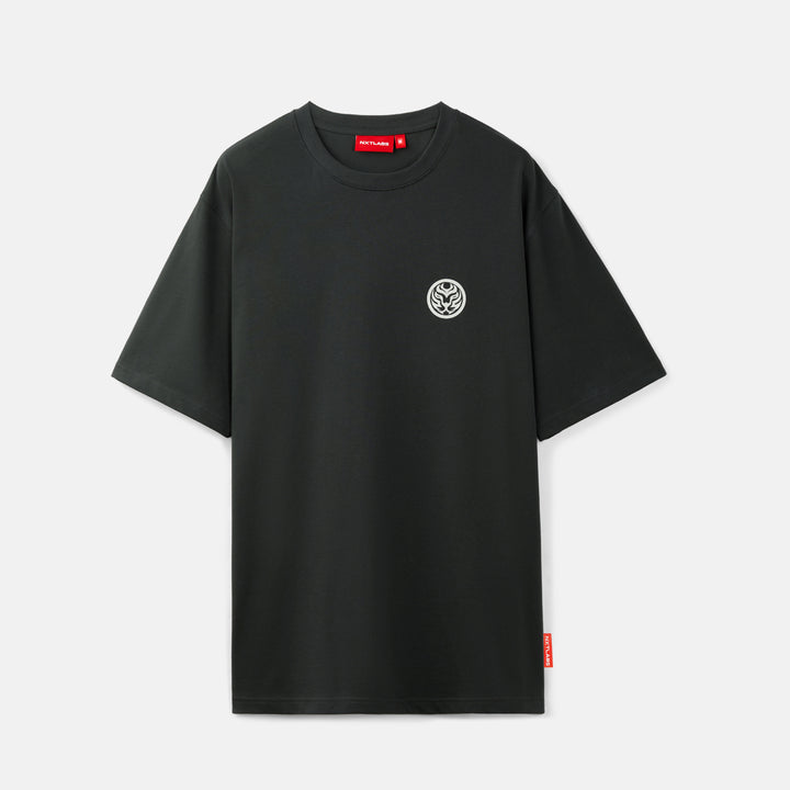 Black t-shirt with a small logo on a light gray background