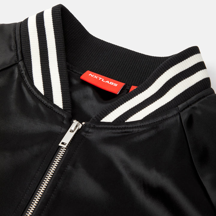 Black jacket with white stripes and a red label on a light gray background