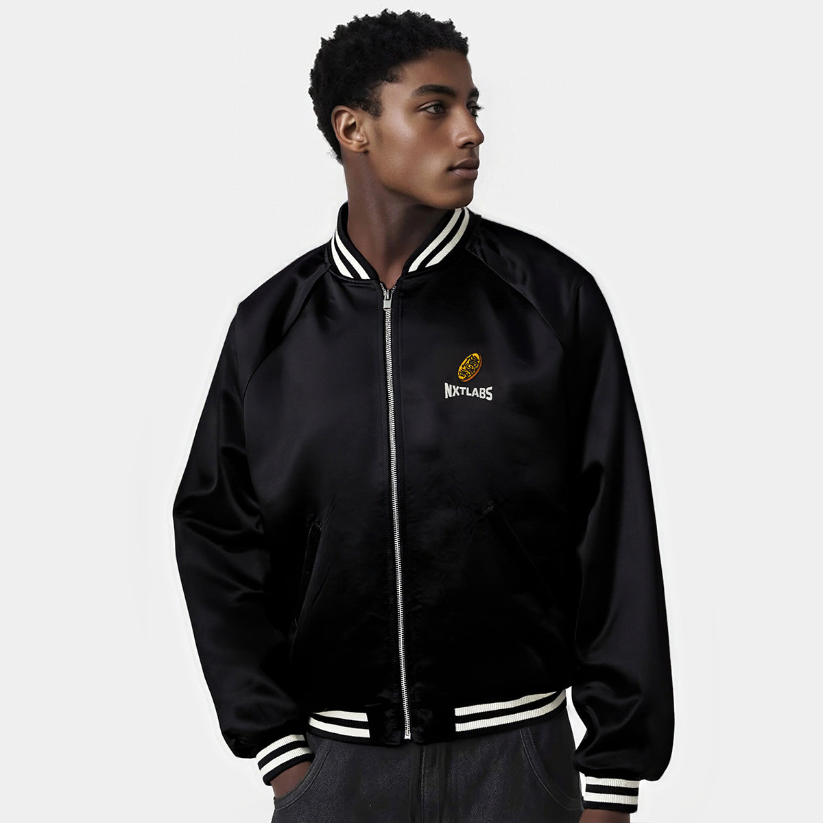 Person wearing a black jacket with a logo on a white background