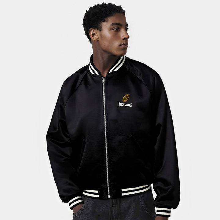 Person wearing a black jacket with a logo on a white background