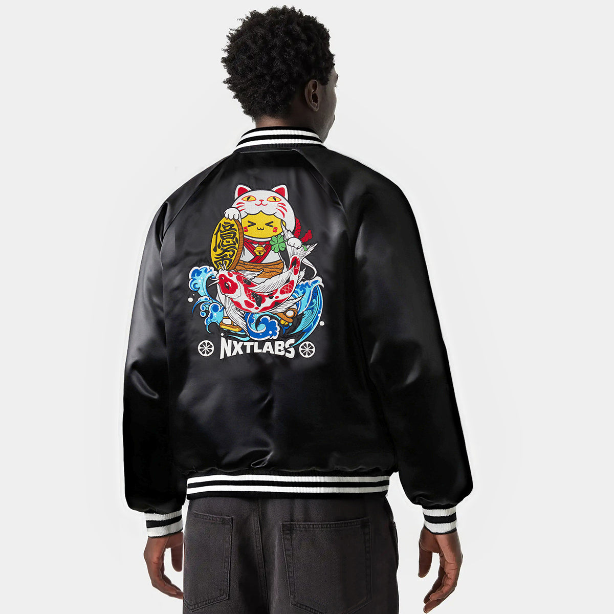 Person wearing a black jacket with a colorful design and 'NXTLABS' branding on the back.