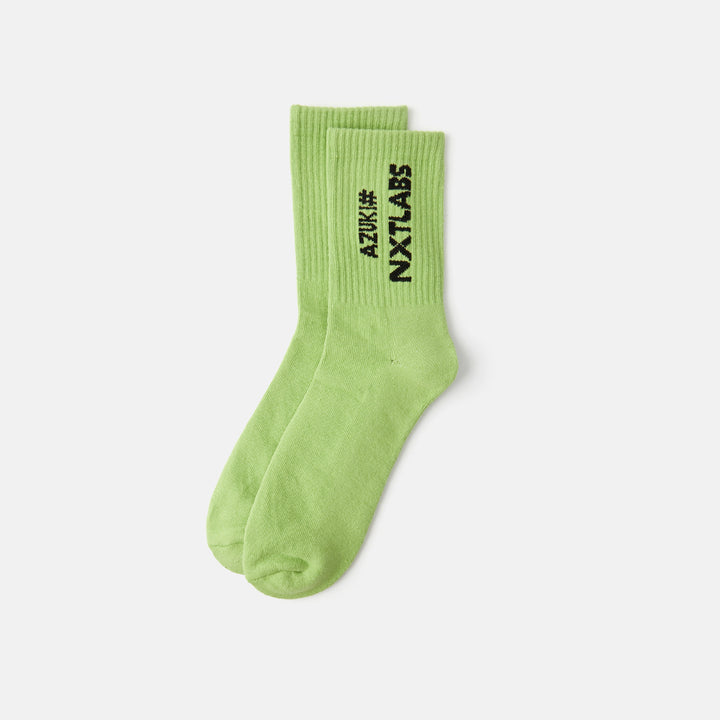 A pair of green crew socks with text 'NXT LABS' on the side.