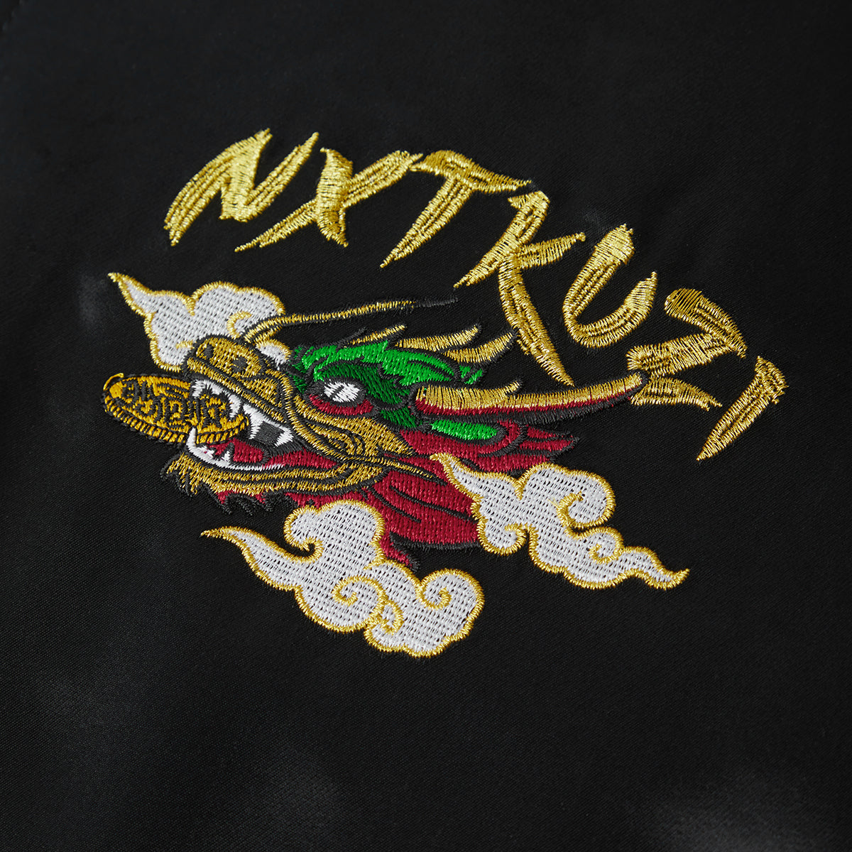 Embroidered dragon design on a black background