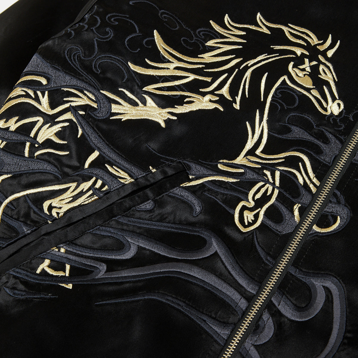 Black jacket with gold embroidered horse design on a dark background