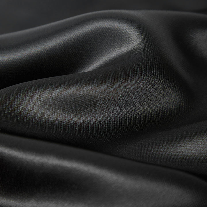 Close-up of dark gray fabric with folds